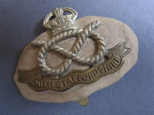 Good original South Staffordshire Regiment cap badge with it's original 'HollandPatch' backing