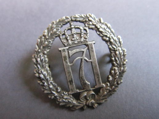 Neat example of a scarce Norwegian Free Forces British made Haakon 7 silver hallmarked capbadge
