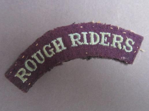 A neat example of a difficult to find shoulder title to the Rough Riders.