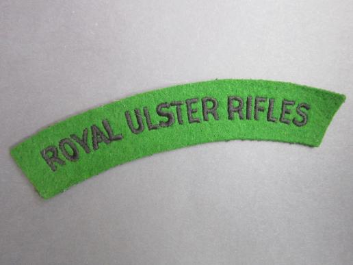 A superb - un-issued - Royal Ulster Rifles green on black embroided shoulder title