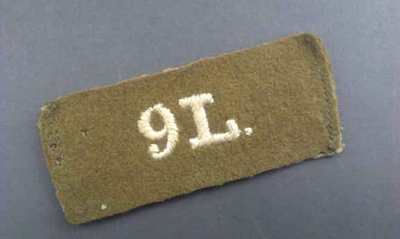 A perfect example of a single Great War period 9L (9th Queen's Royal Lancers) slip-on shoulder title