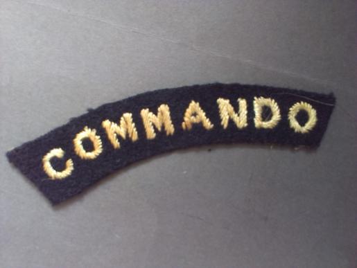A good example of a early single white on black Commando shoulder title