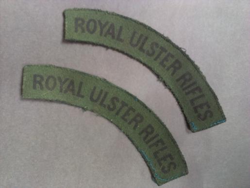 A perfect example of a difficult to find full matching set of issued printed Royal Ulster Rifles shoulder titles 