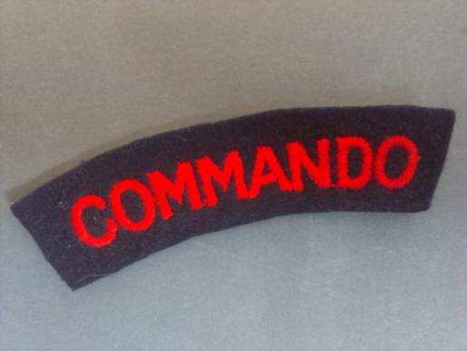 A nice un-issued red on black Commando shoulder title