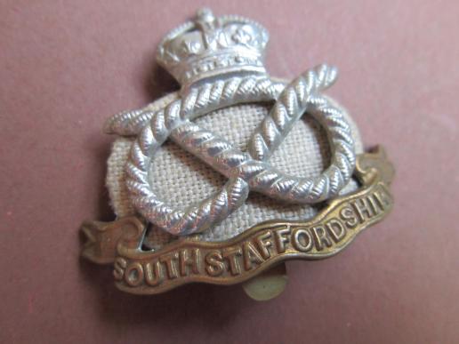 A good original South Staffordshire Regiment cap badge with it's original 'HollandPatch' backing