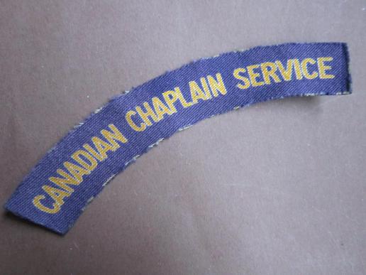 A difficult and sought after example of a British made Canadian Chaplain Service printed shoulder title