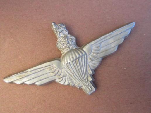 A perfect and issued example of a plastic cap badge to The Parachute Regiment