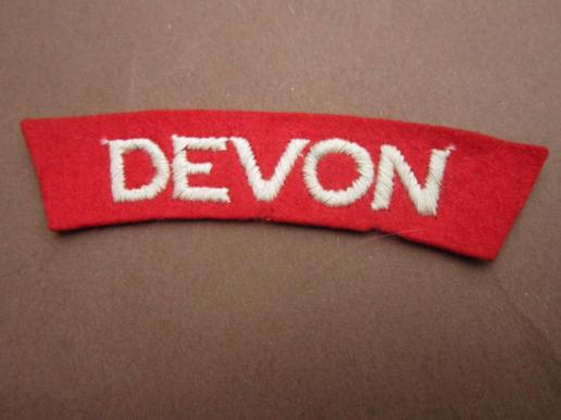 A nice and un-issued embroided Devonshire Regiment shoulder title