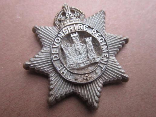 A nice plastic cap badge to the Devonshire Regiment 