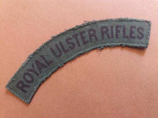 A perfect example of a difficult to find and issued printed Royal Ulster Rifles shoulder title