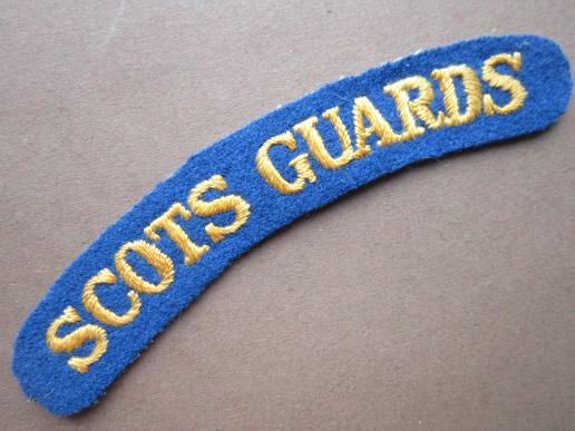 A nice and early un-issued embroided Scots Guards shoulder title