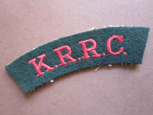 A early embroided K.R.R.C. (King's Royal Rifle Corps) red on dark green shoulder title