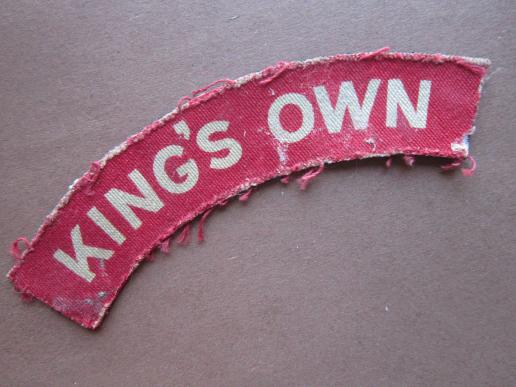A nice issued King's Own white on red printed clorh shoulder title