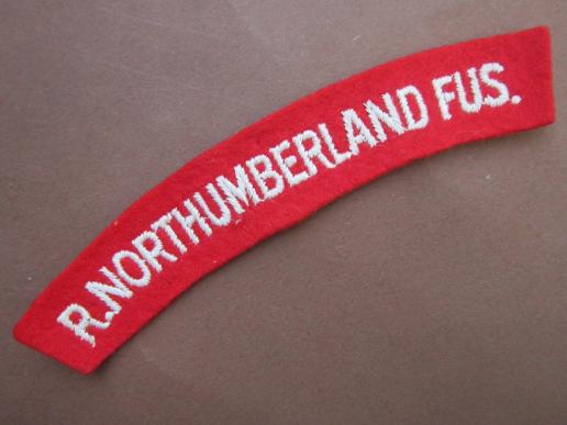 A nice white on red Royal Northumberland Fusiliers paste i.e glue back embroided shoulder title 