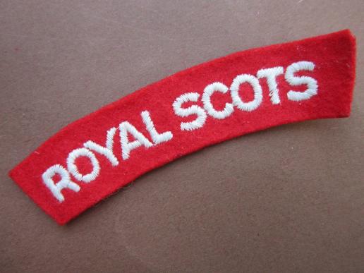 A nice white on red embroided Royal Scots paste i.e gleu back shoulder title