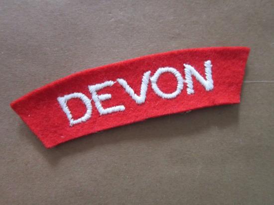 A nice and un-issued hand embroided Devonshire Regiment shoulder title