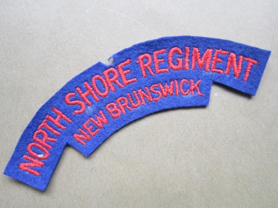 A un-issued British made North Shore Regiment New Brunswick shoulder title