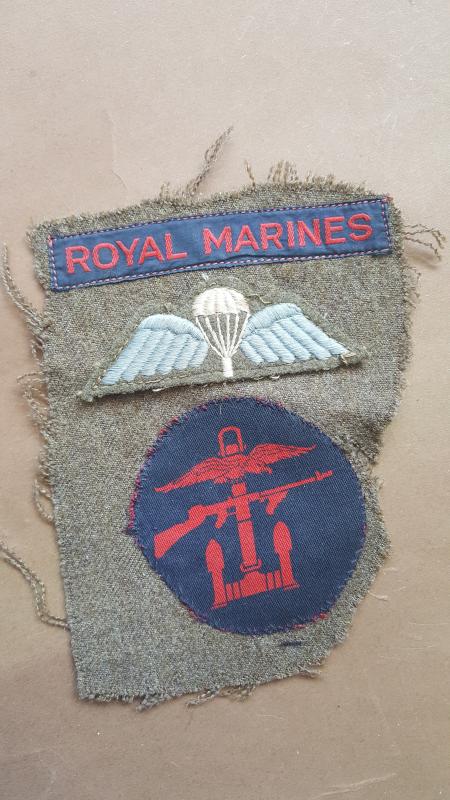 A neat example of a set of badges to the Royal Marines Commando still on a piece of Battle Dress