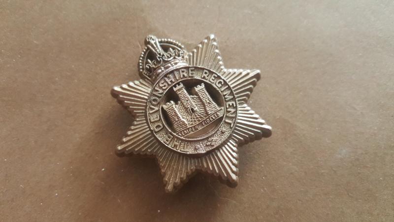 A nice plastic cap badge to the Devonshire Regiment