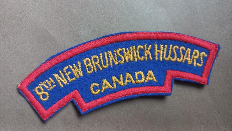 A nice and un-issued British made Canadian shoulder title to the 8th New Brunswick Hussards, 5th Armoured Regiment