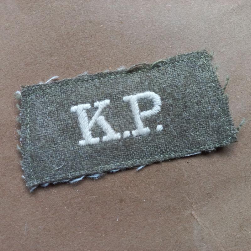 A nice British made not so often seen Polish K.P. (1 Korps Polski) shoulder title i.e slip-on