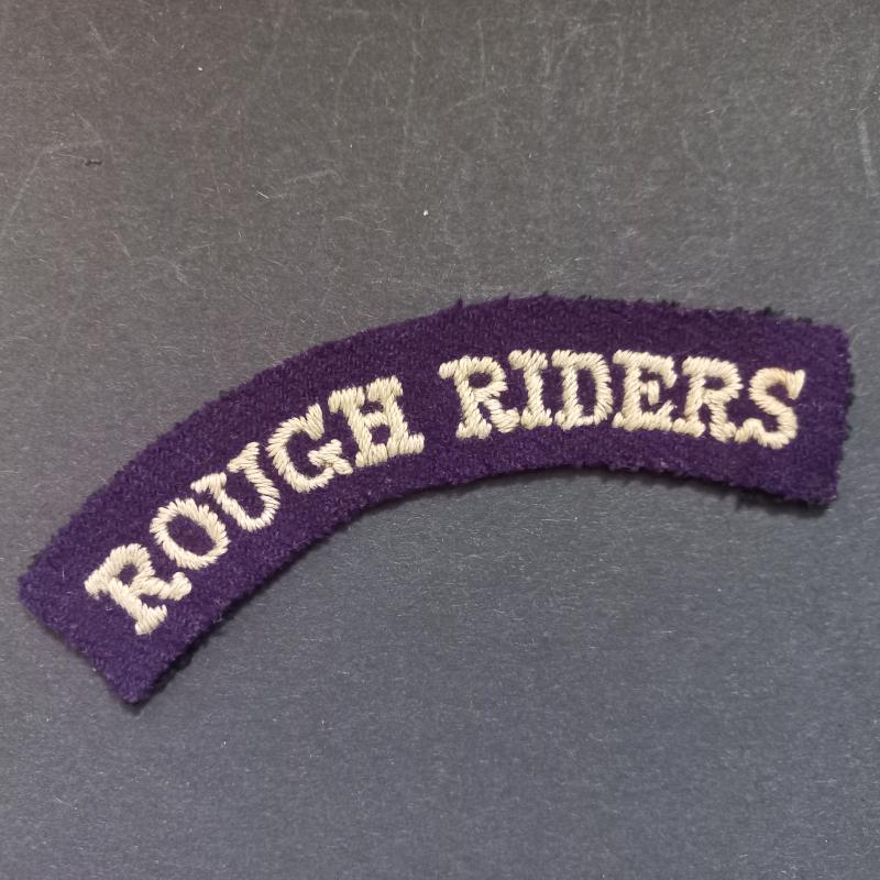 A superb early war time (regrettably single) embroided British made Rough Riders shoulder title