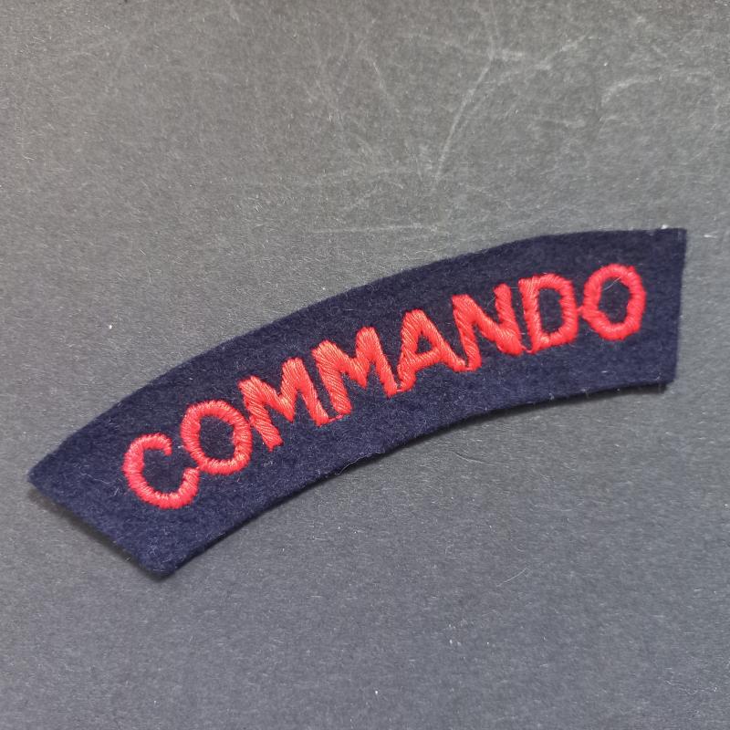 A nice un-issued red on black embroided - regrettably single - Commando shoulder title