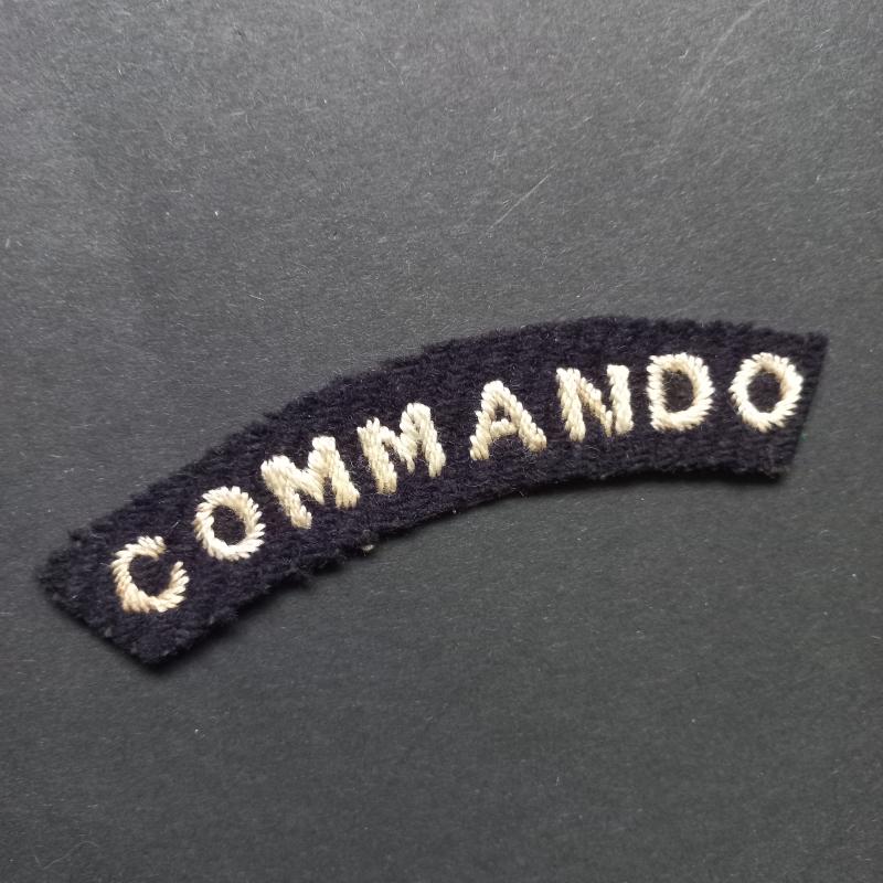 A superb - albeit regrettably single - early white on black embroided commando shoulder title