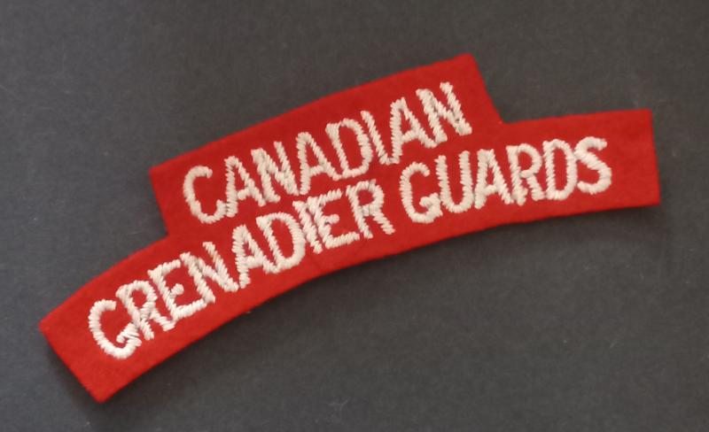 A superb - typical British made - Canadian Grenadier Guards white on red embroided shoulder title