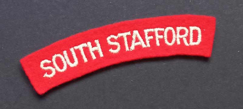 A neat un-issued (white on red) embroided South Stafford shoulder title