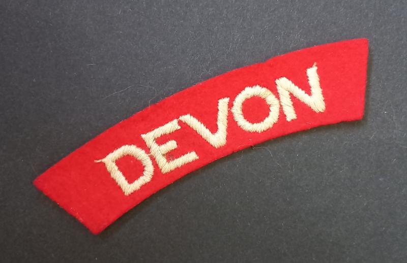 A nice - un-issued standard embroided - Devonshire Regiment shoulder title