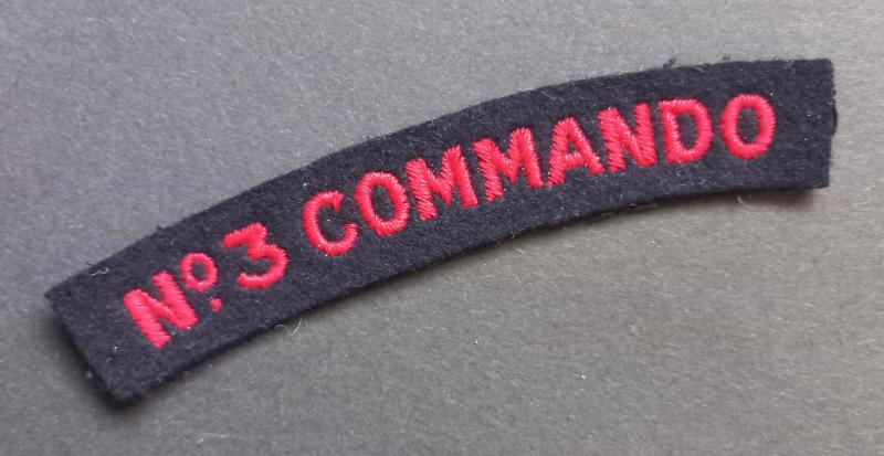 A nice un-issued red on black embroided - regrettably single - Number 3 Commando shoulder title