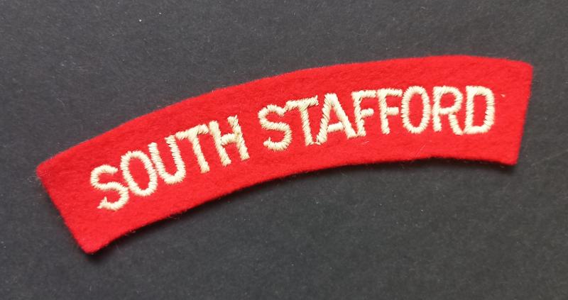 A neat un-issued (white on red) embroided South Stafford shoulder title