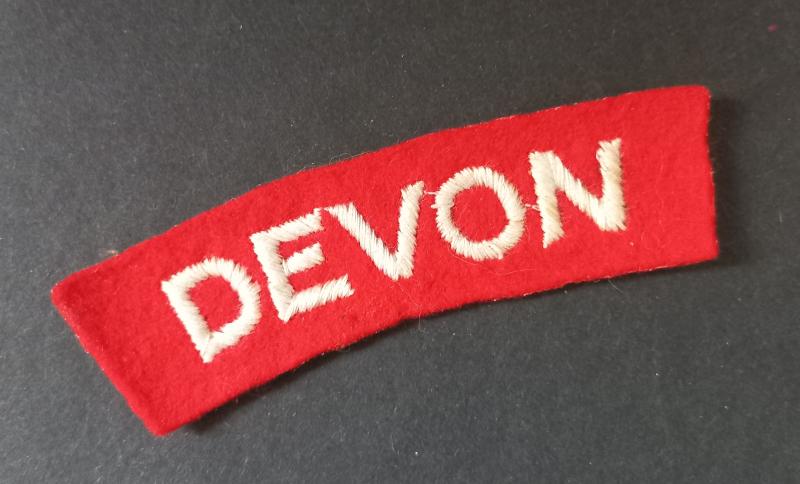 A nice - un-issued standard embroided - Devonshire Regiment shoulder title