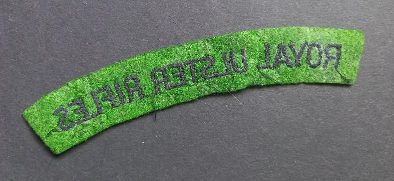 A attractive - un-issued - Royal Ulster Rifles black on green embroided shoulder title