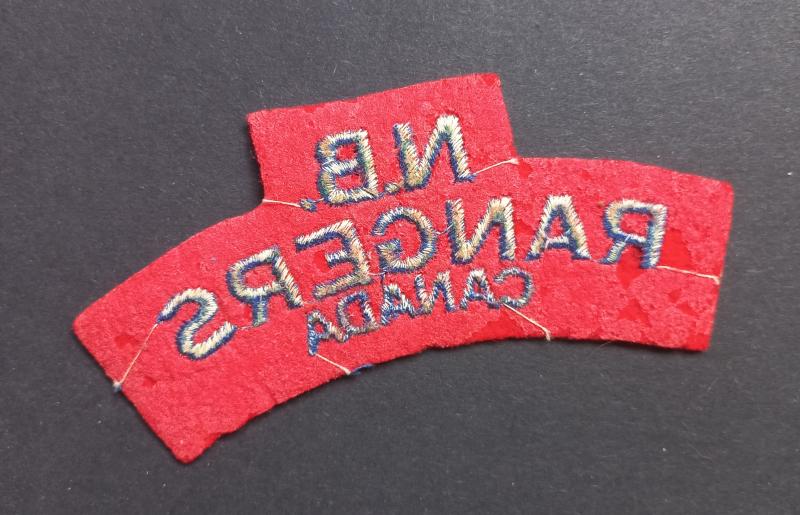 A nice un-issued British made Canadian N.B. (New Brunswick) Rangers embroided shoulder title