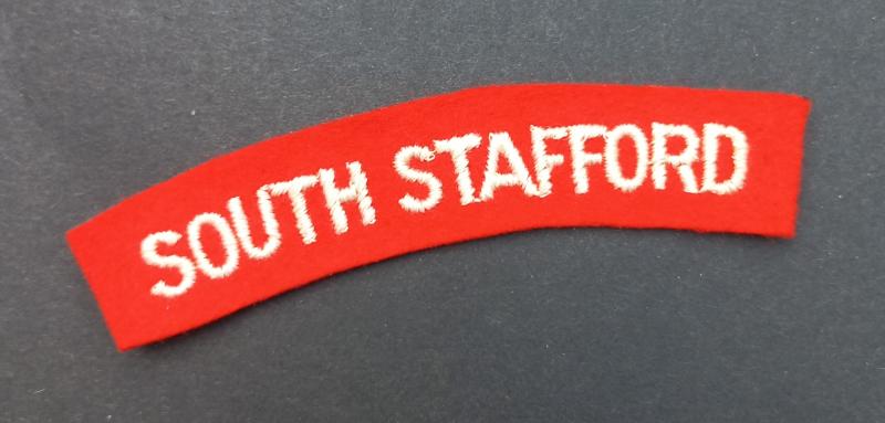 A neat un-issued (white on red) embroided South Stafford shoulder title