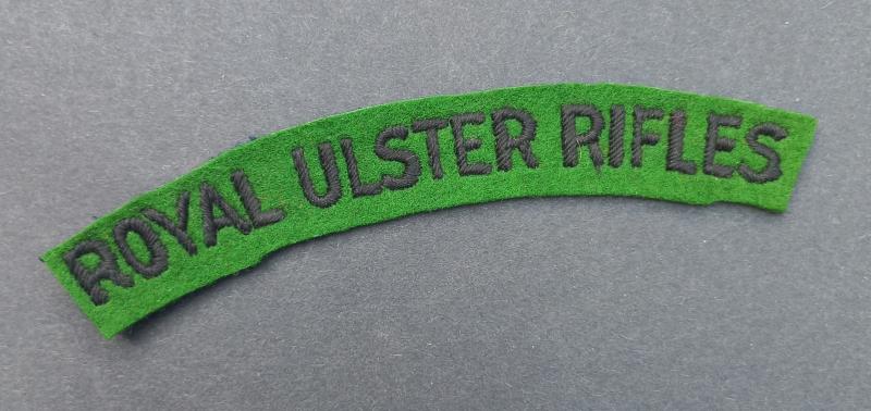 A attractive - un-issued - Royal Ulster Rifles black on green embroided shoulder title