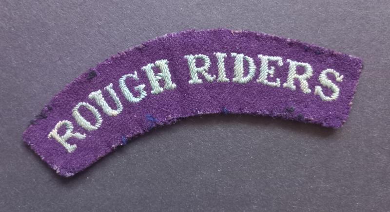 A superb early war time (regrettably single) embroided British made Rough Riders shoulder title