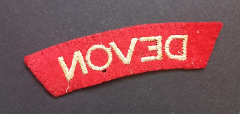 A nice - issued standard embroided - Devonshire Regiment shoulder title