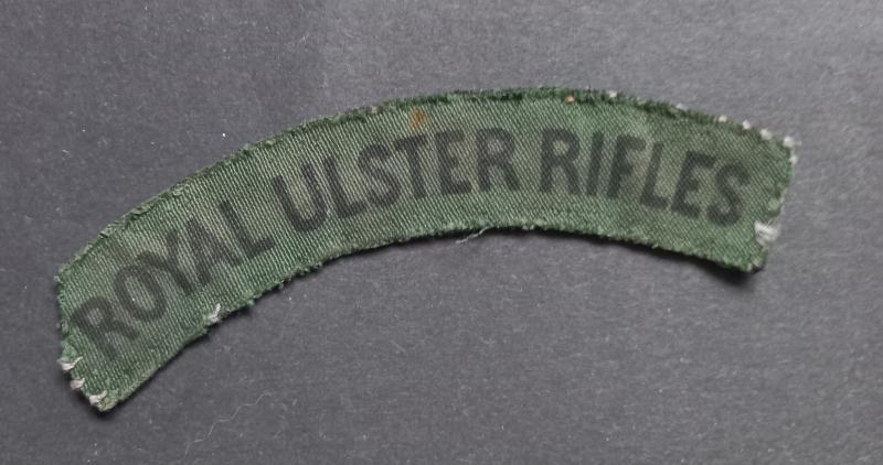 A nice example of a (difficult to find and issued) printed Royal Ulster Rifles shoulder title
