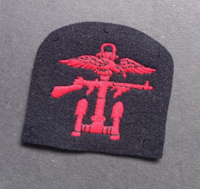 A perfect - right facing - single embroided Combined Operation formation badge