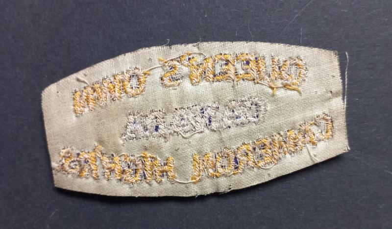 A neat (un-issued white backing) British made Canadian Queens Own Cameron Highlanders shoulder title